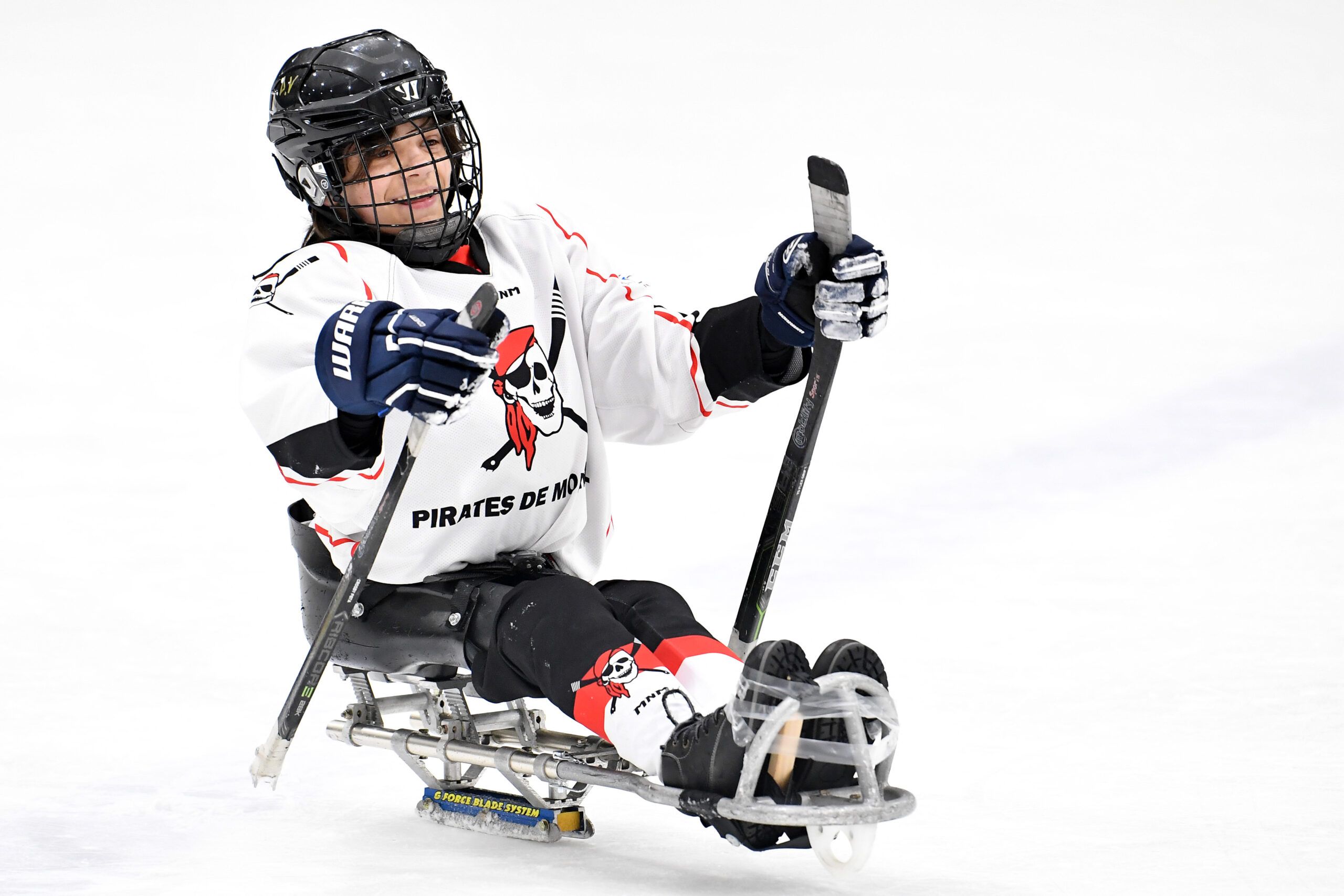 Un joueur de parahockey junior se déplace sur la patinoire.